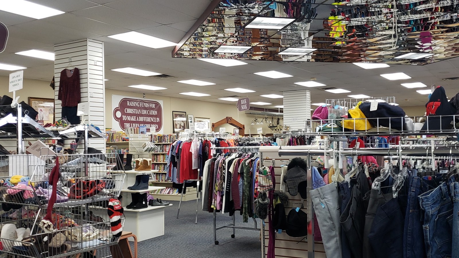 Clothing racks and accessory displays inside Fair Market Thrift Store