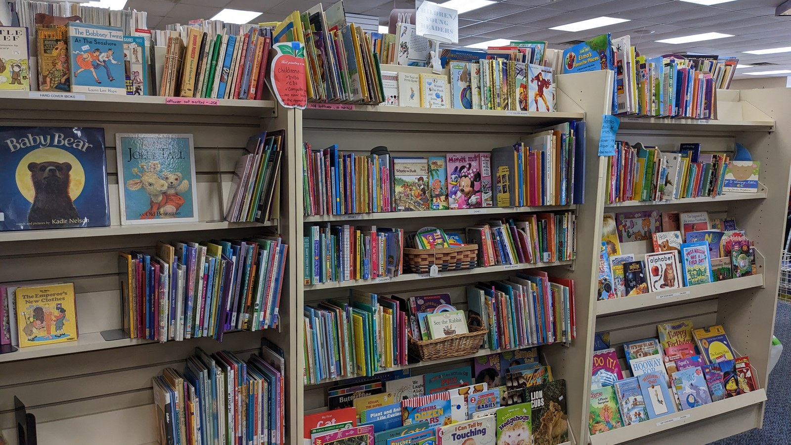 Shelves filled with colorful children's books at Fair Market Thrift Store
