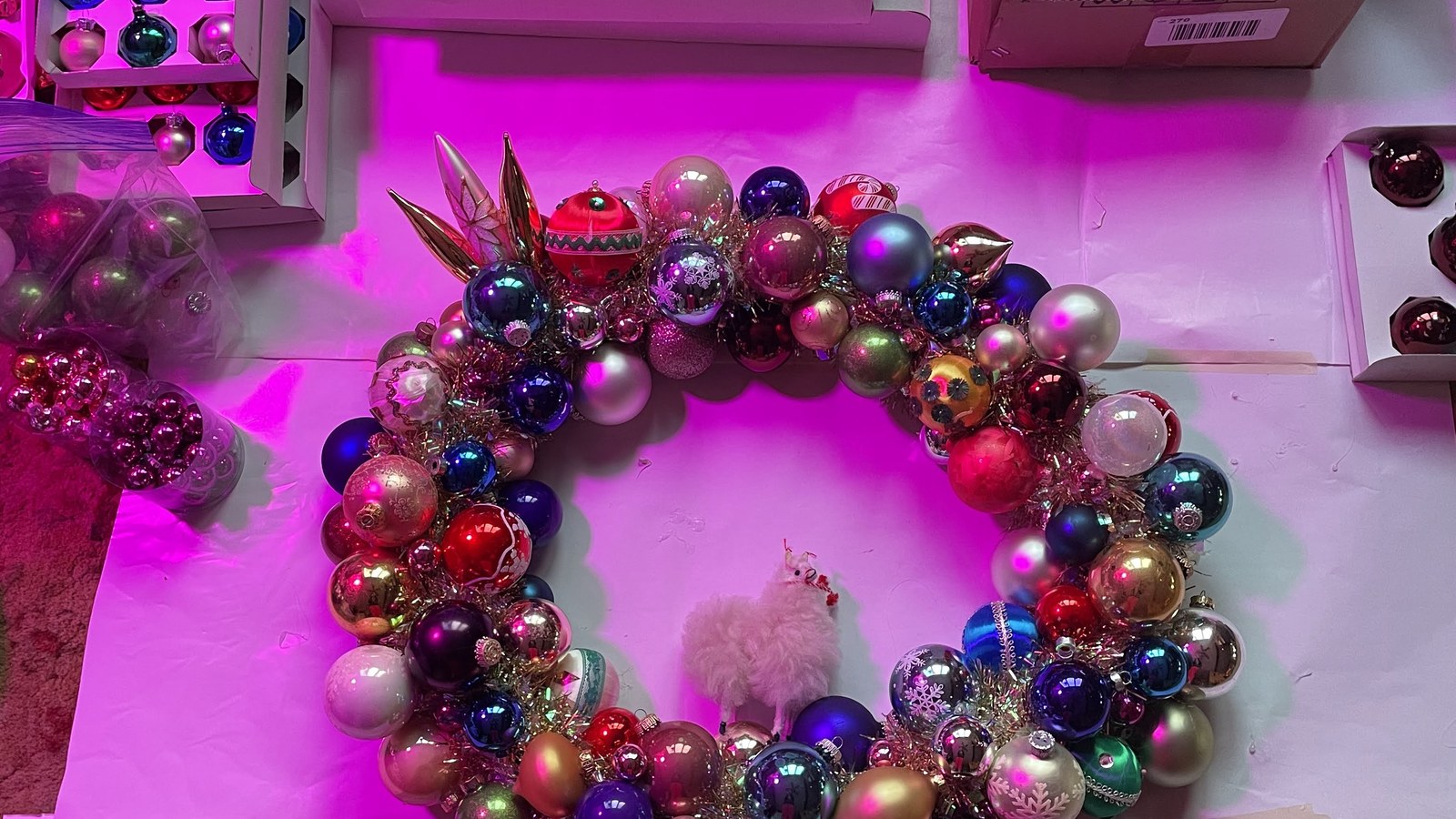 Colorful ornament wreath displayed among seasonal decorations