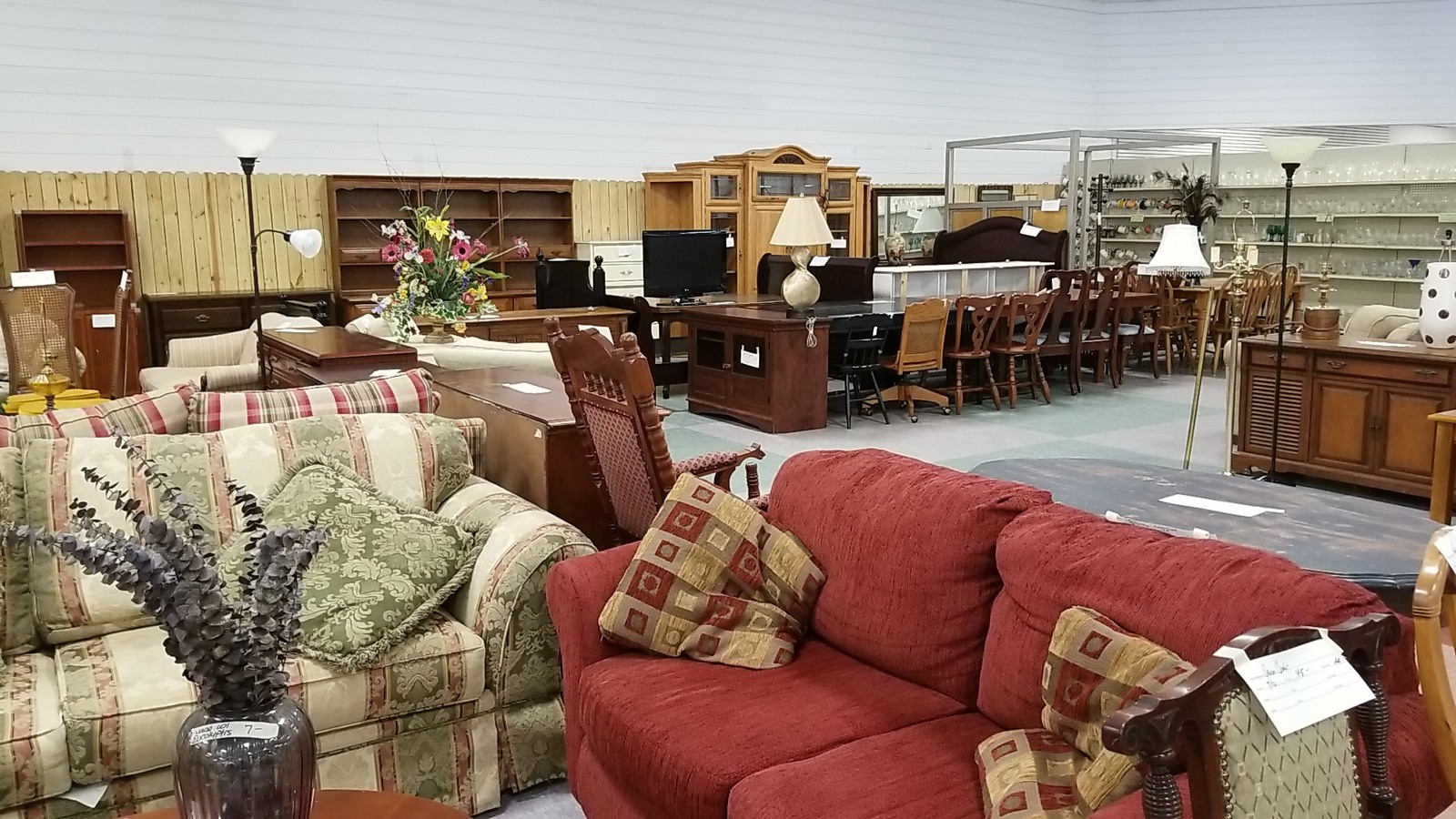 Sofas and home furniture grouped on the thrift store floor