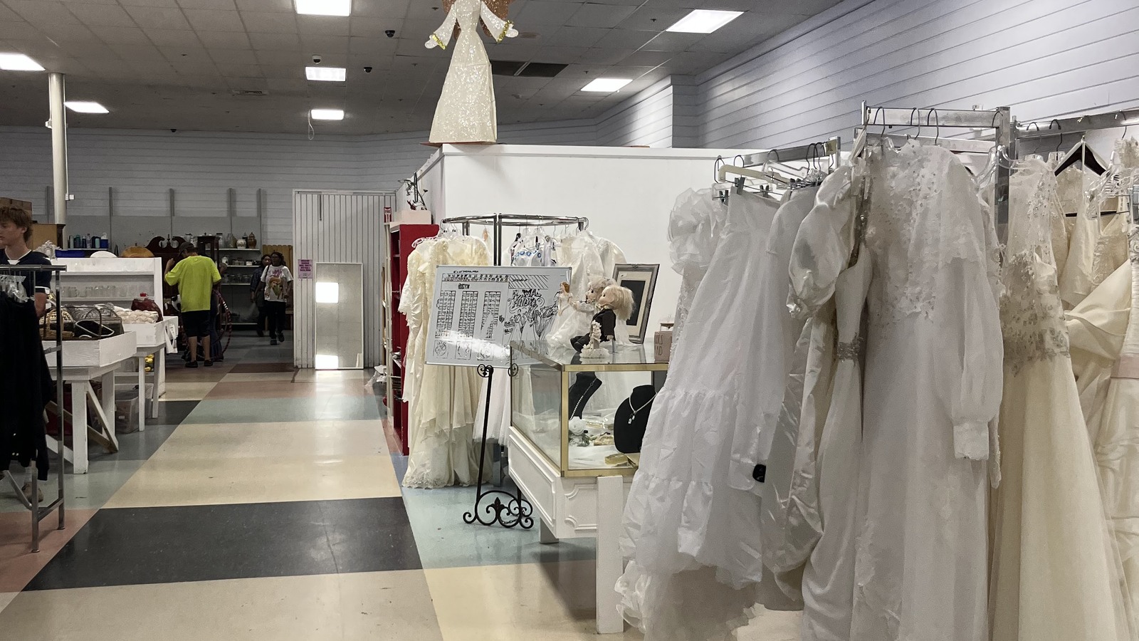 Bridal gowns hanging together in a specialty clothing section