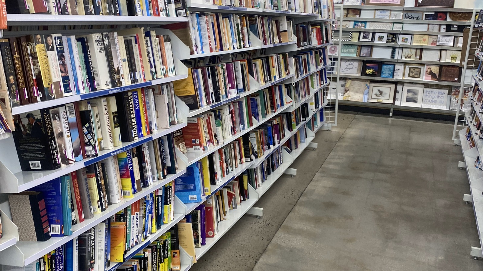 Long book aisle filled with hardcovers and paperbacks