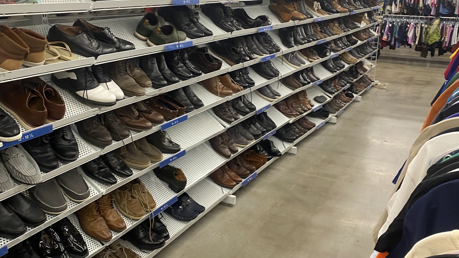Dress shoes and casual footwear arranged on long shelves