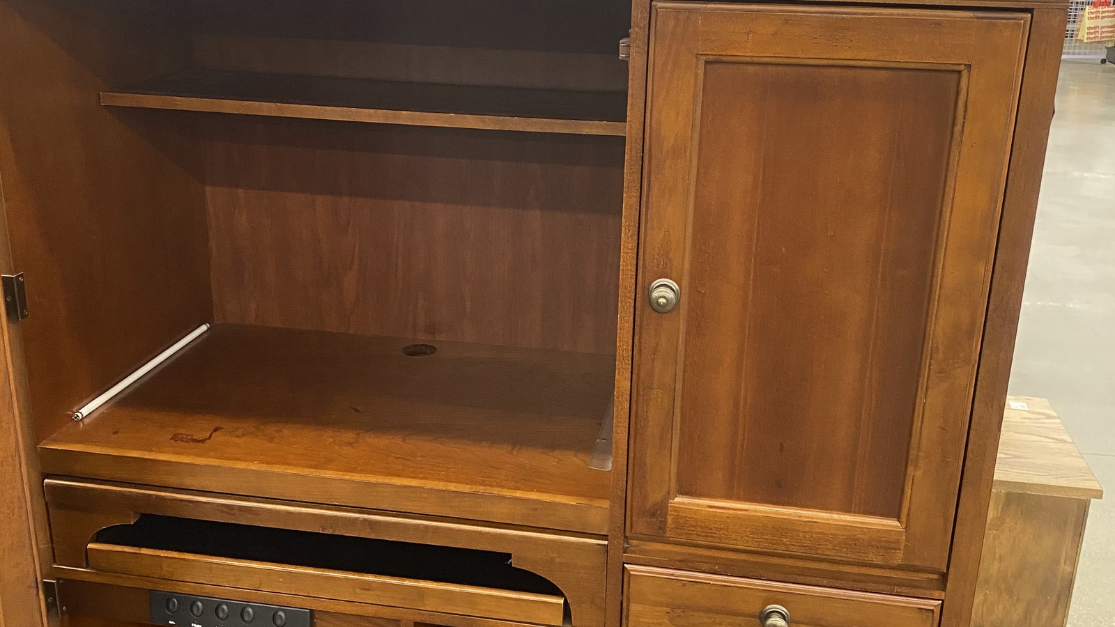 Tall wooden media cabinet in the furniture department