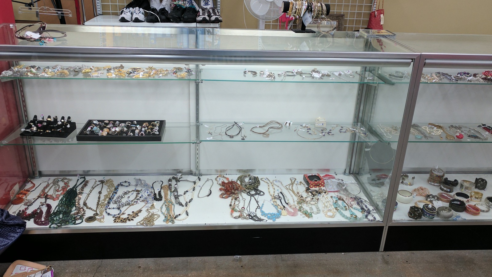 Jewelry and small accessories displayed in a glass case