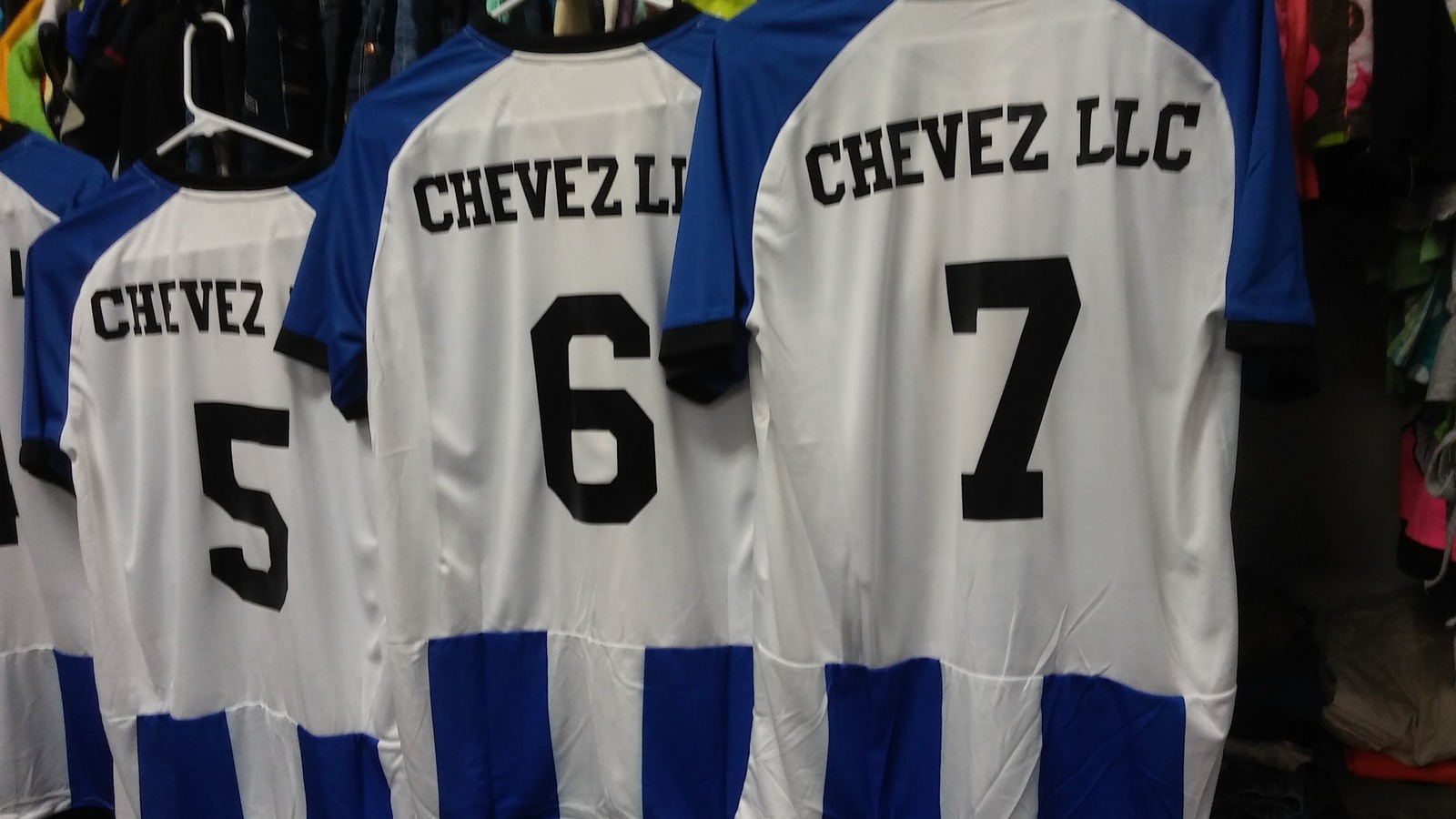 White and blue personalized soccer jerseys with large numbers