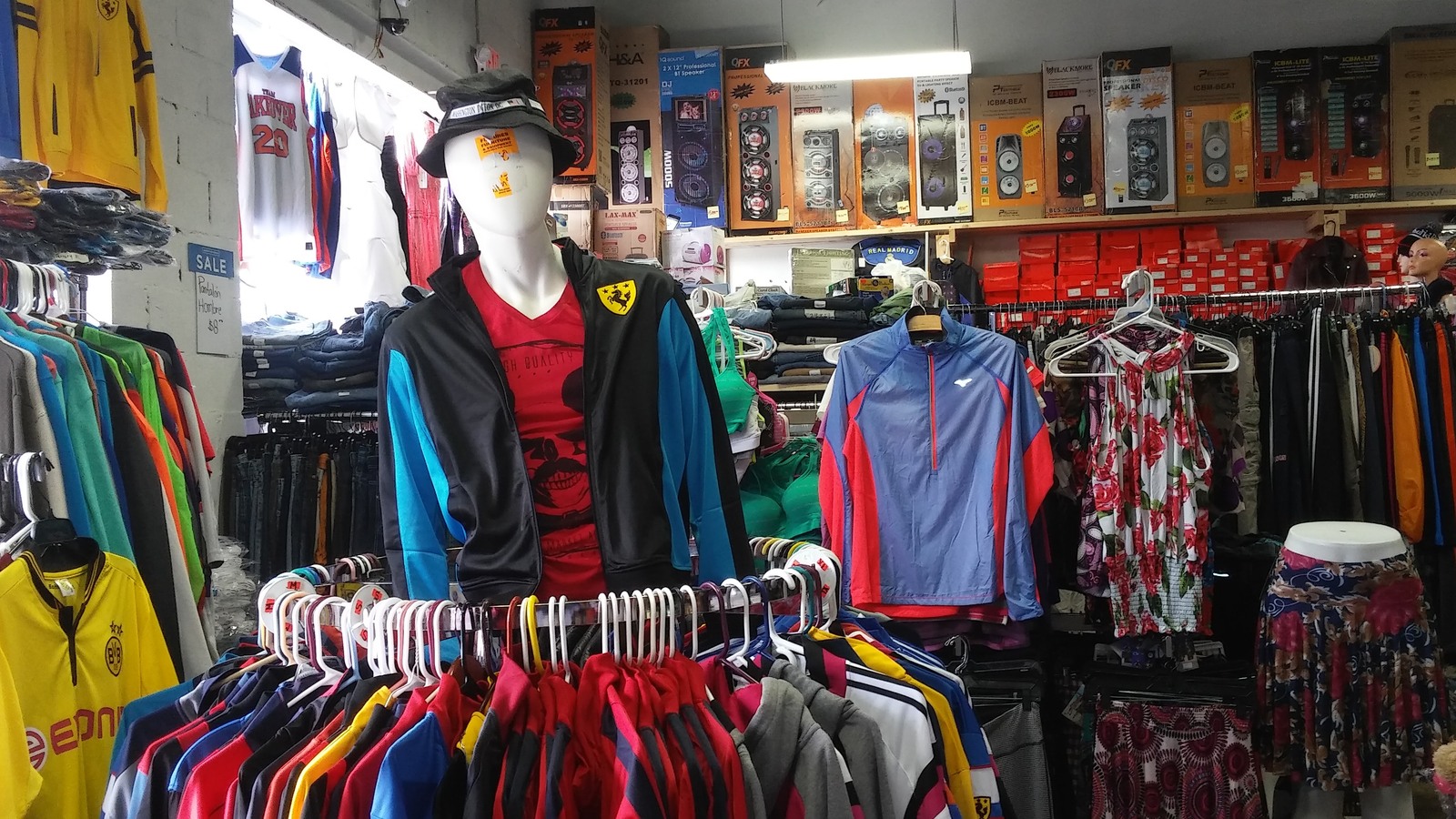 Mannequin and layered racks of colorful apparel