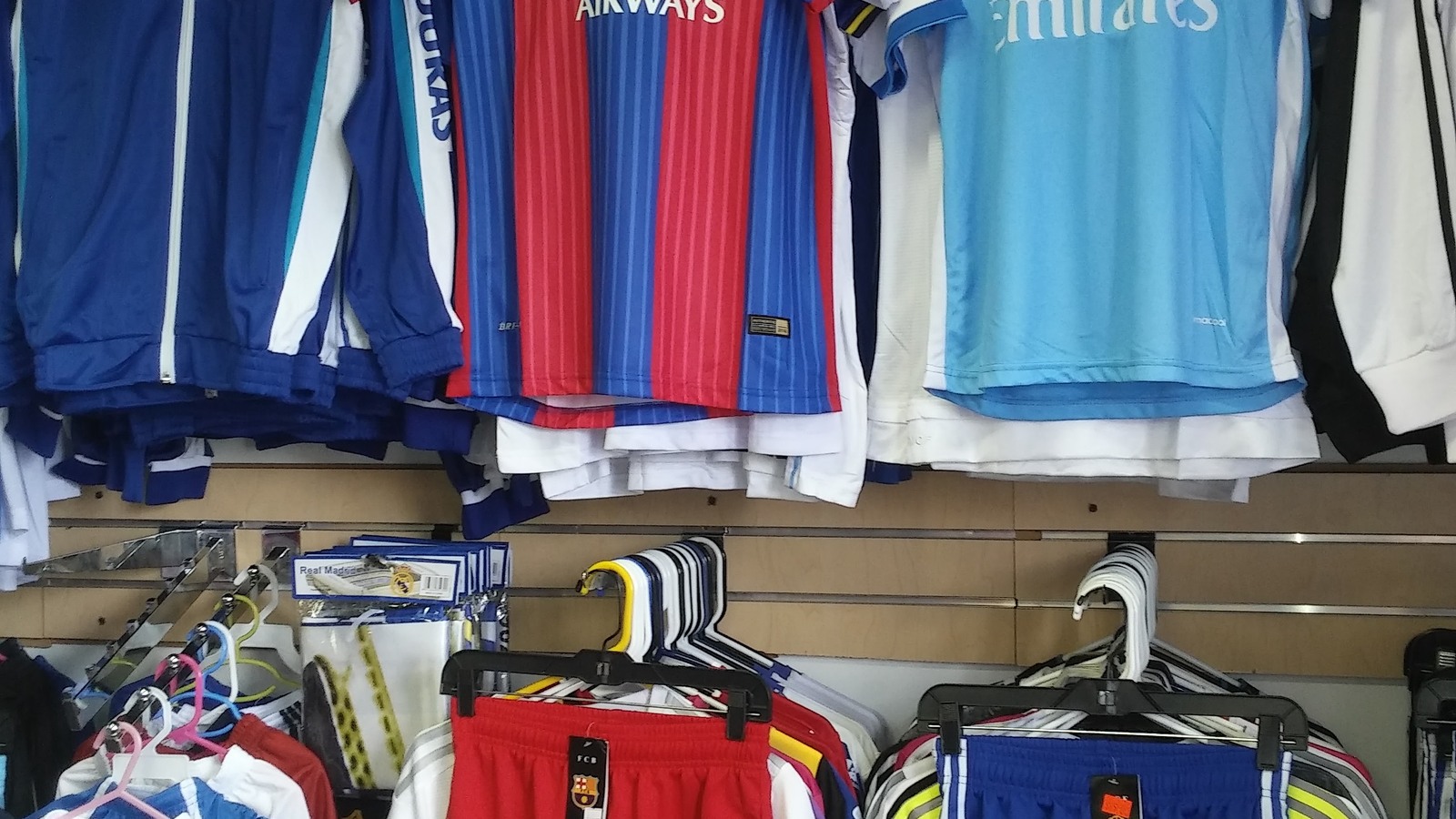 Soccer shirts and athletic shorts arranged by color