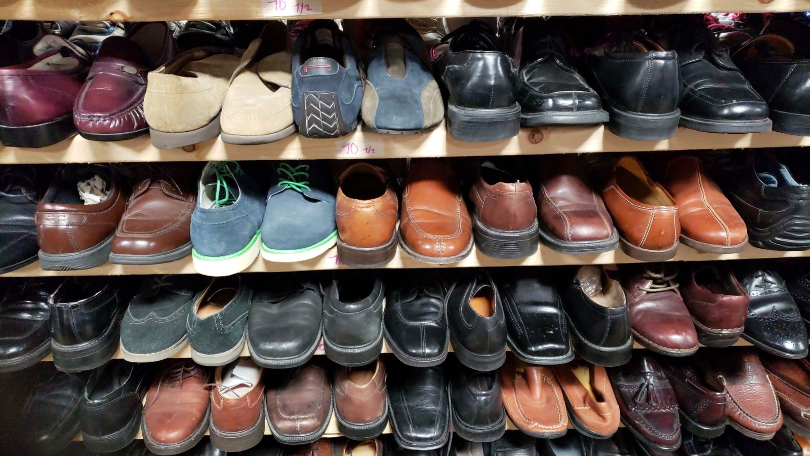 Dress shoes and casual footwear organized on shelves