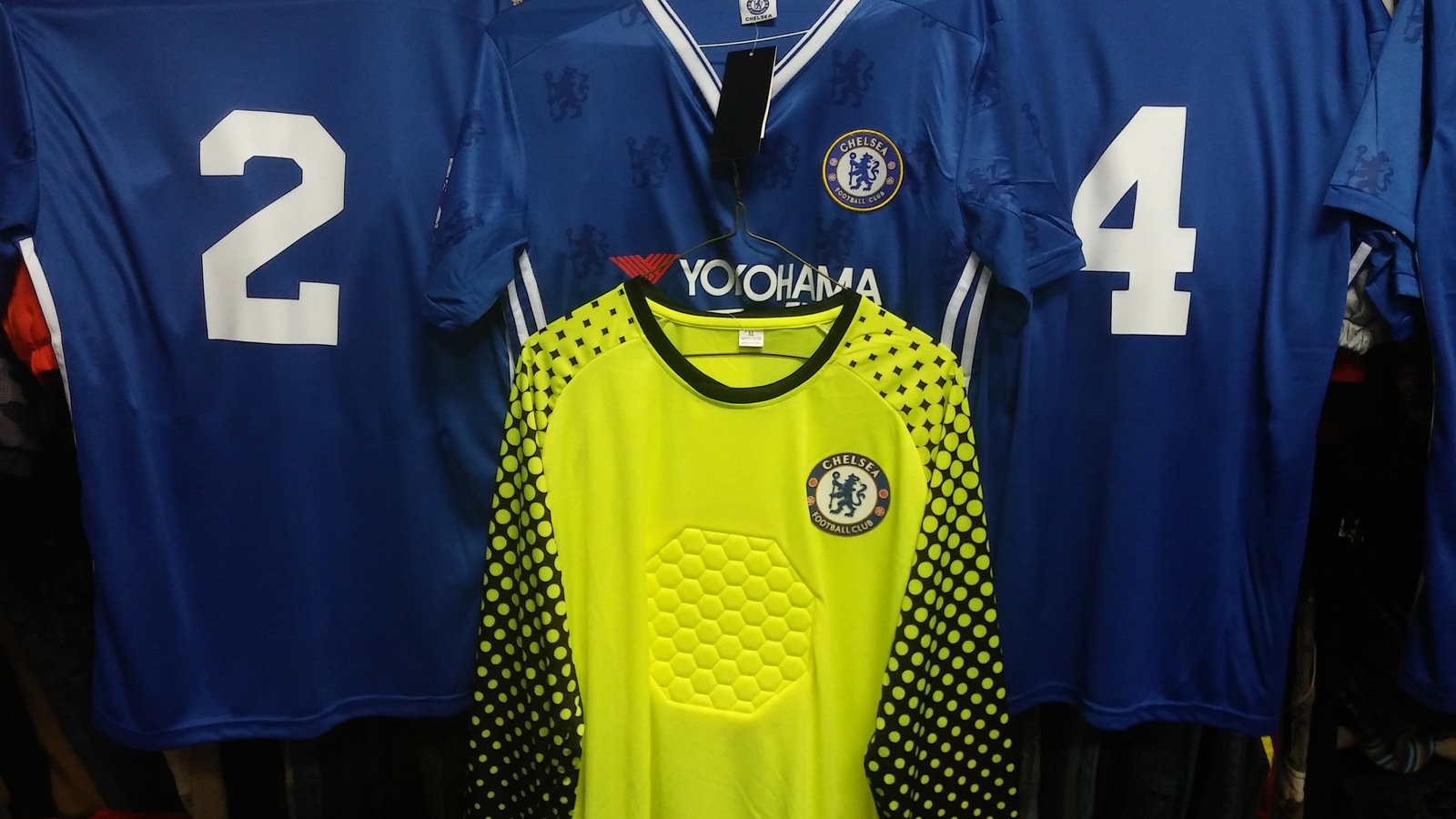 Blue soccer shirts and bright goalkeeper jersey
