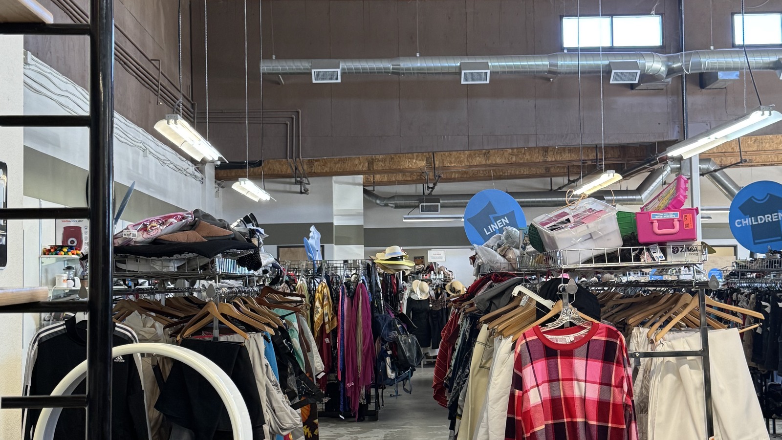 Clothing racks across the Angel View resale floor in Hemet