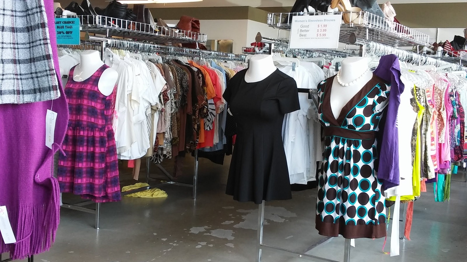 Colorful dresses hanging beside clothing racks