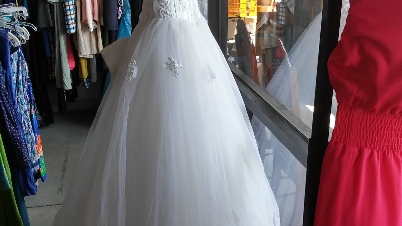 White and red formal dresses on display