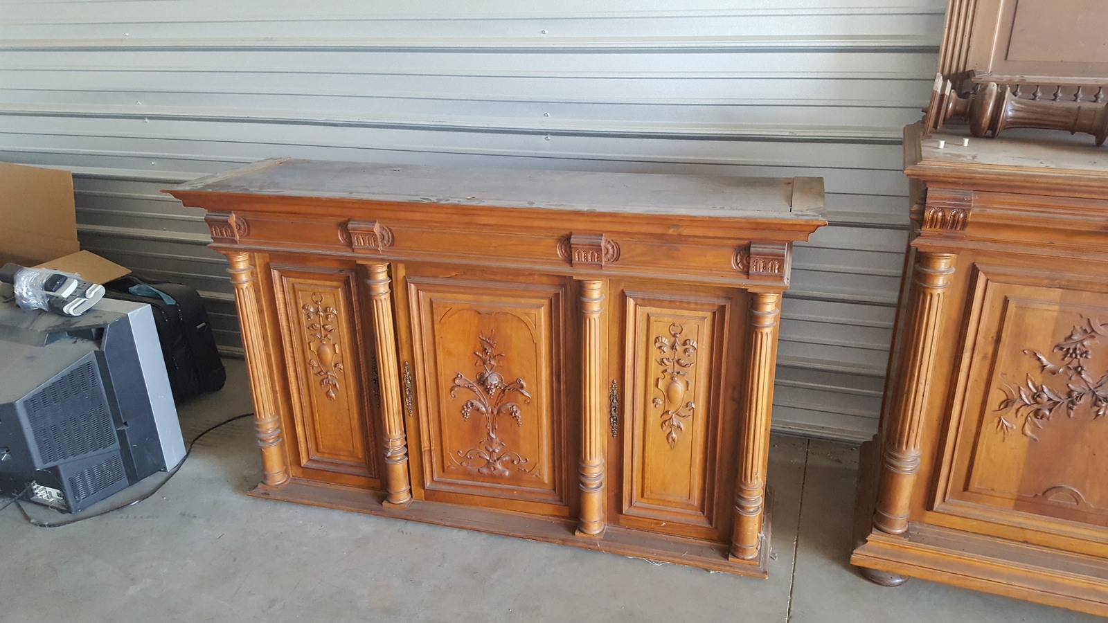 Carved wooden cabinet with paneled doors