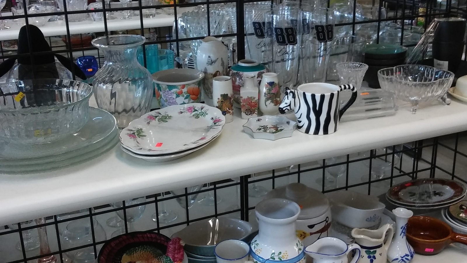 Dishes, mugs, and glassware arranged by shape and color