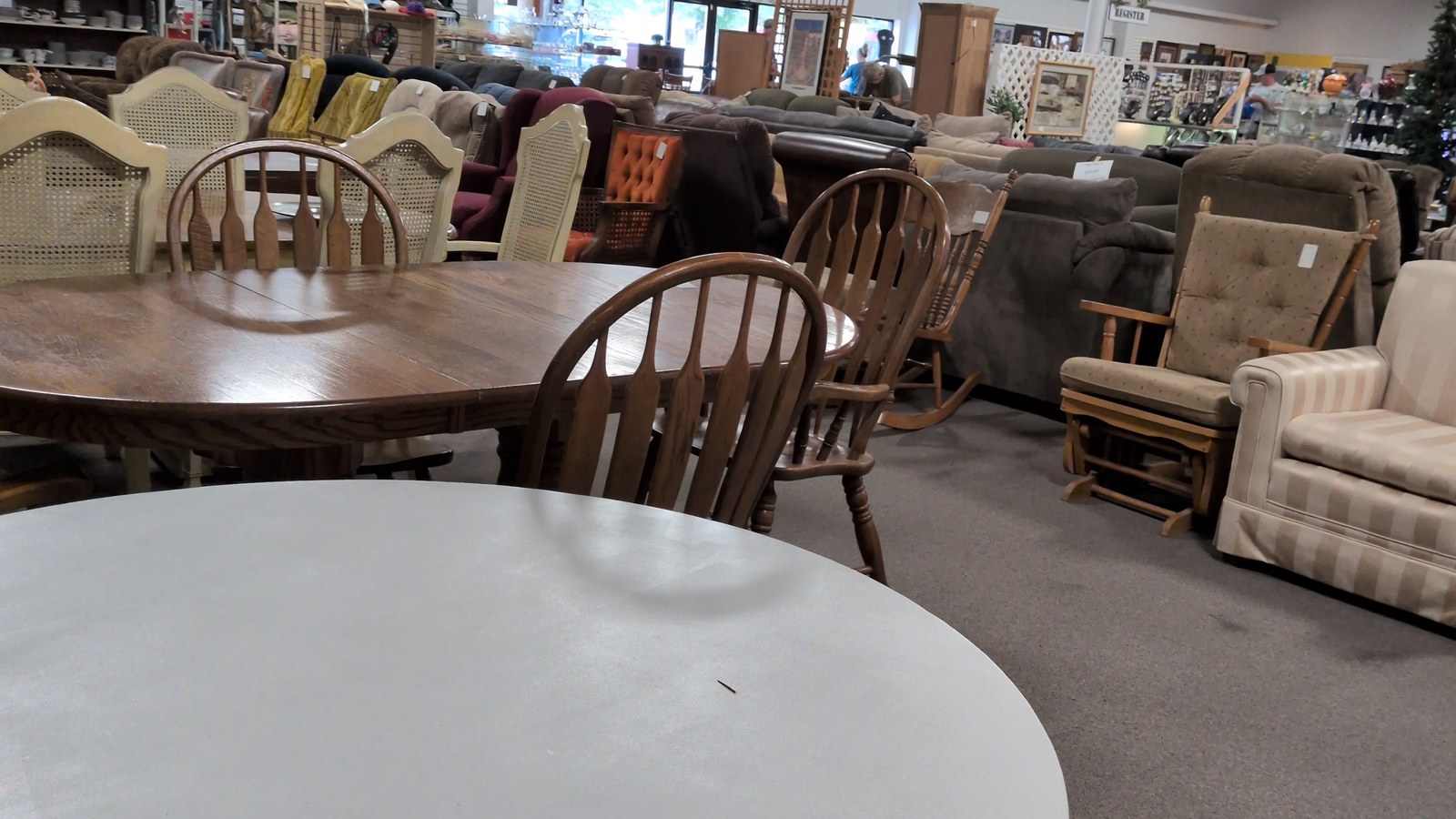Dining tables, chairs, and upholstered furniture on the VINE sales floor
