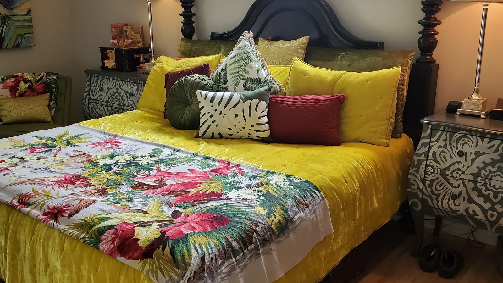 Colorful bed, lamps, and patterned pillows arranged as a bedroom display