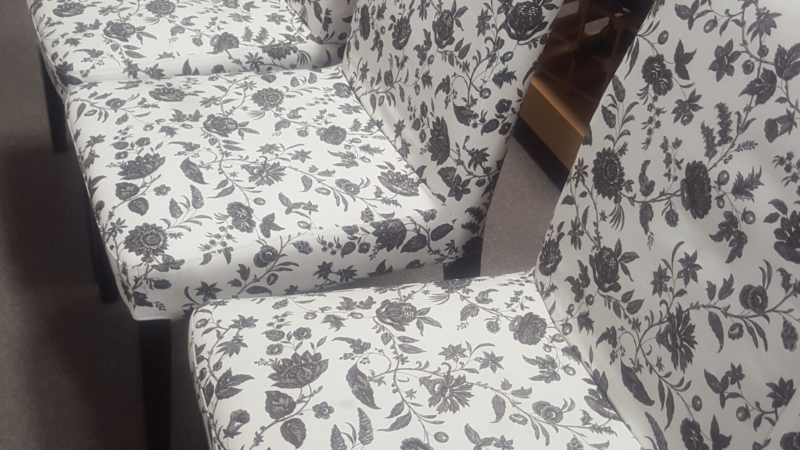 Pair of floral upholstered chairs on the furniture floor