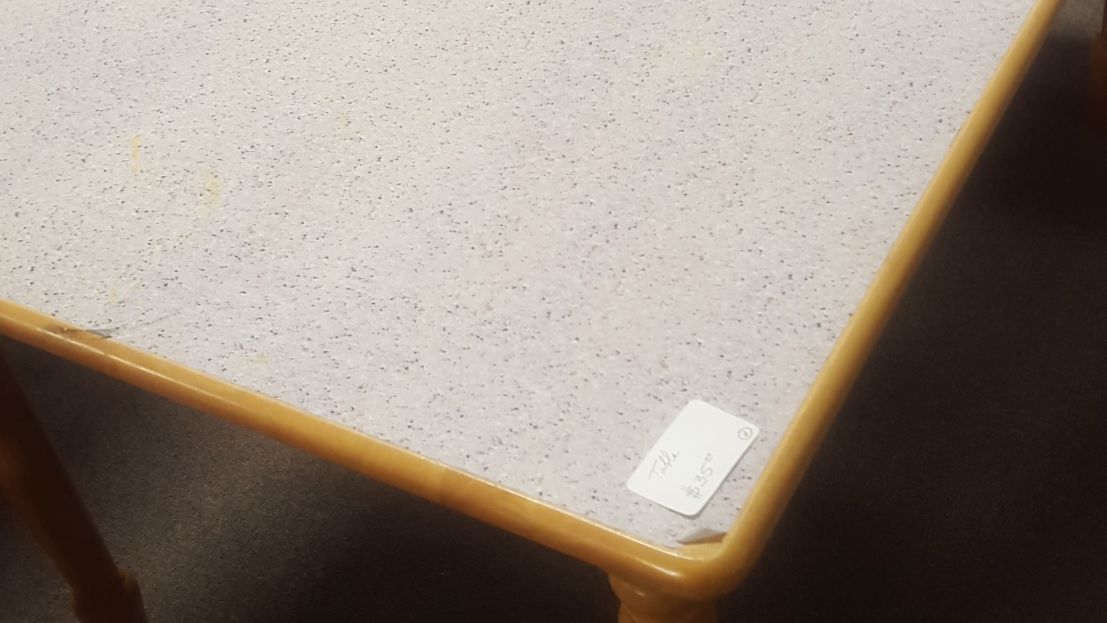 Retro speckled laminate table with a wood-trimmed edge