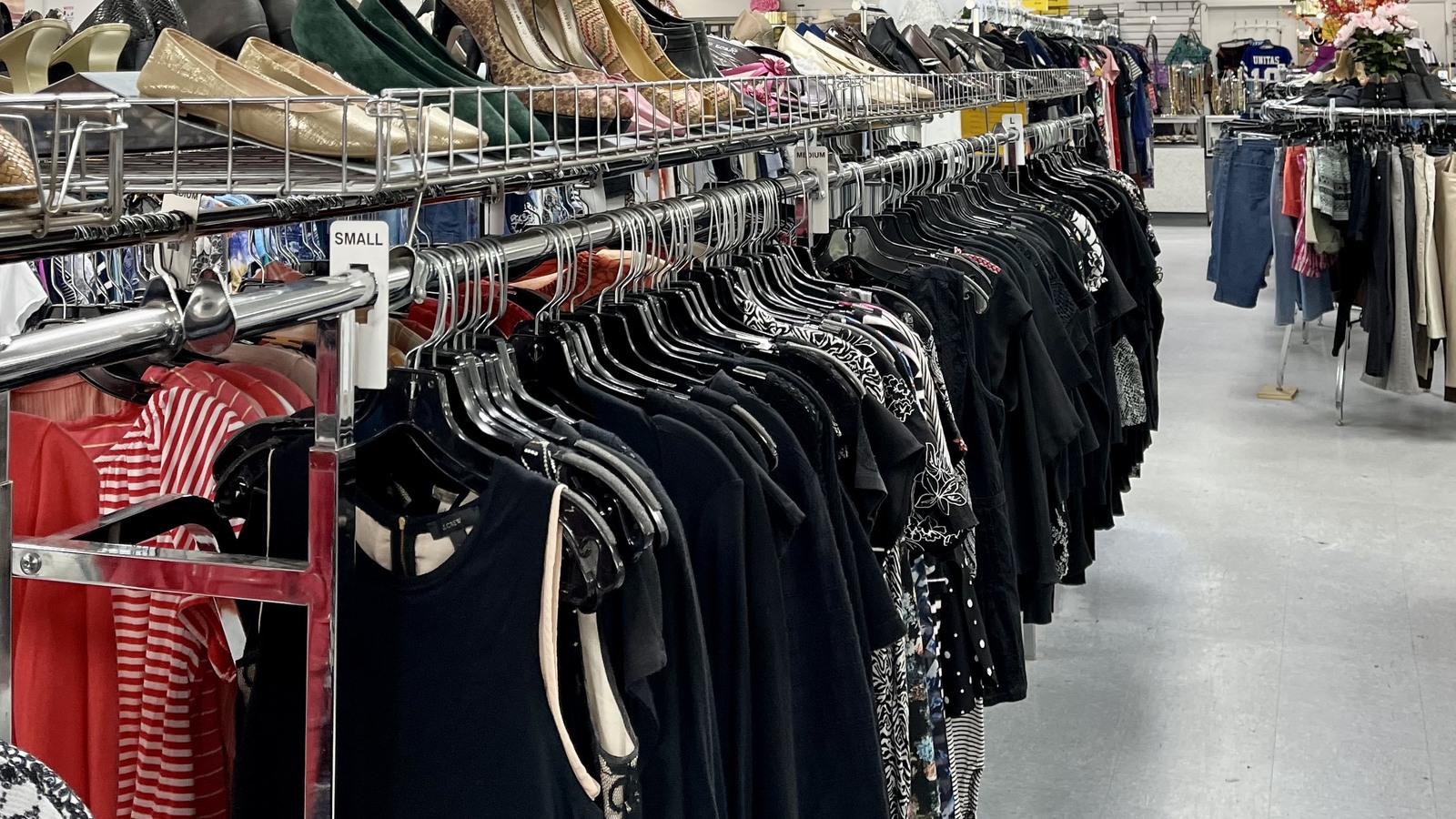 Neatly arranged clothing racks inside Holy Redeemer Thrift Store