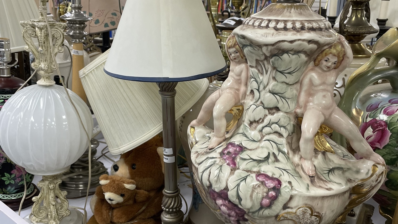 Table lamps and ornate ceramic décor gathered on display