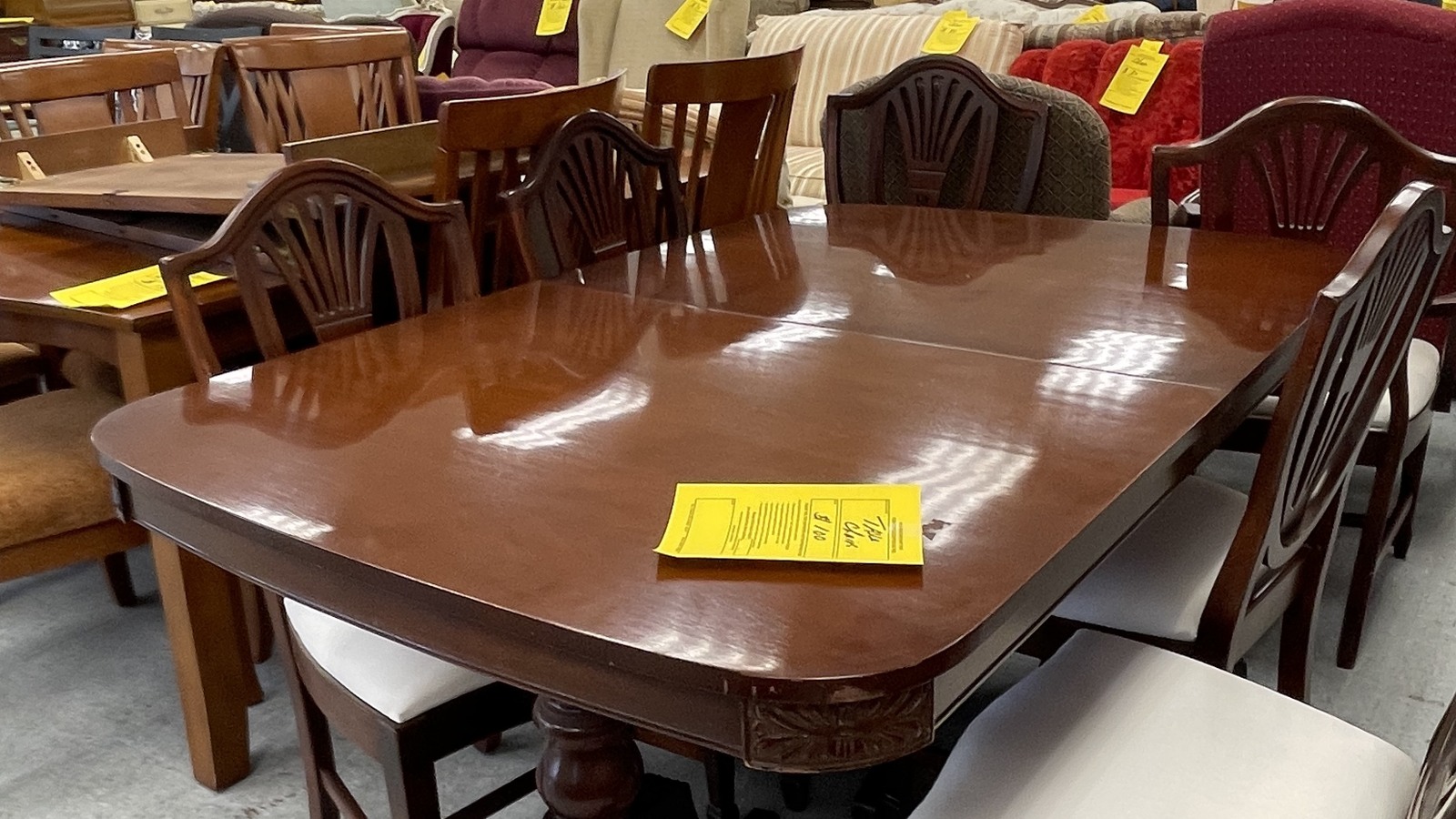 Dining tables and chair sets arranged across the furniture department