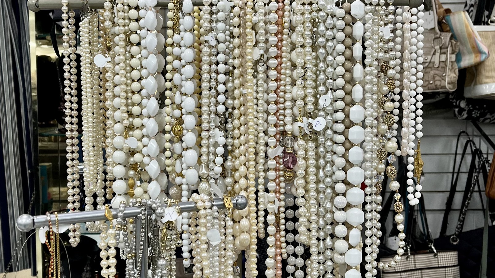 Strands of pearl-style necklaces and costume jewelry on display