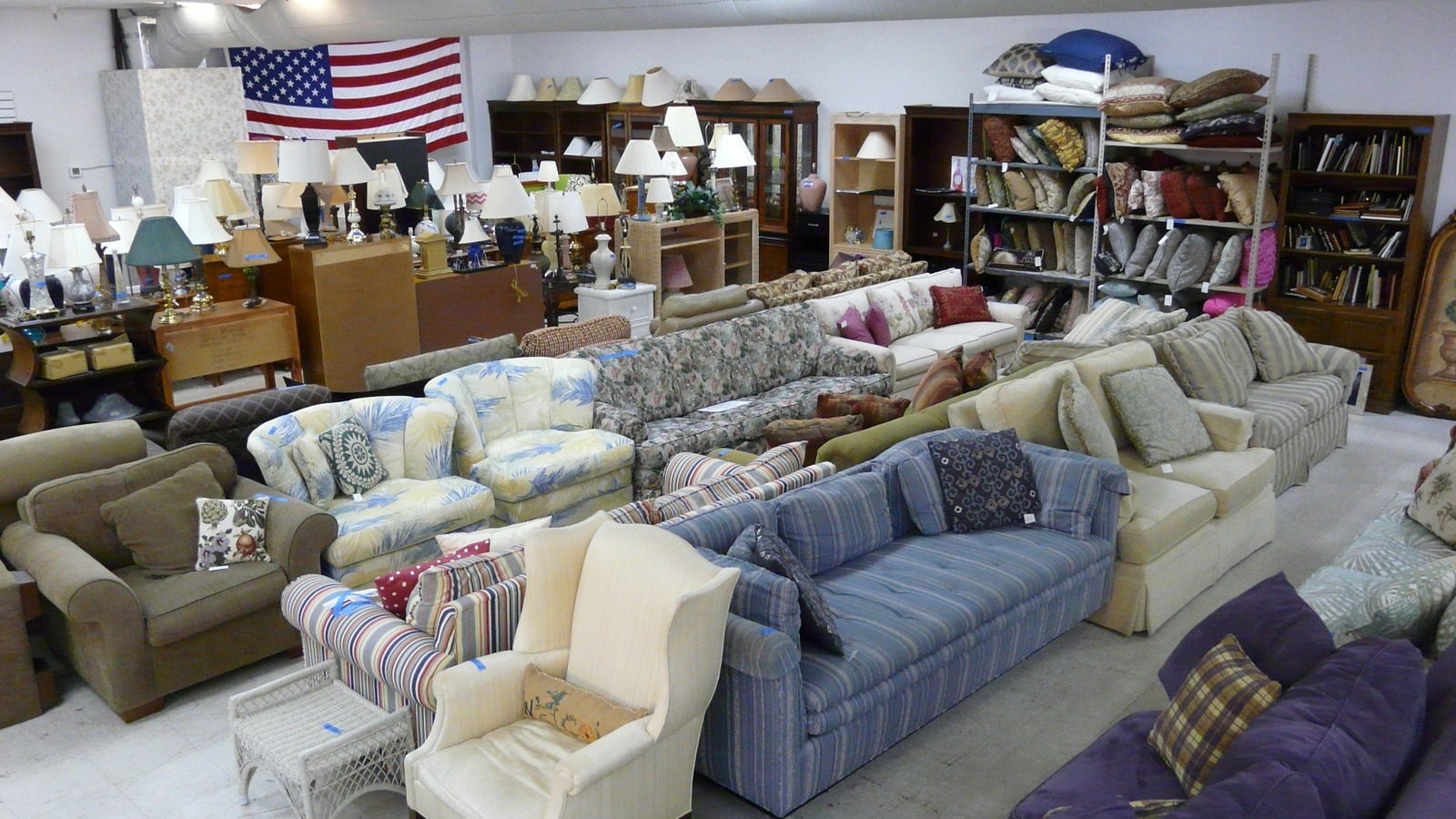 Sofas lamps and bookshelves in the St. Francis Thrift Shop furniture room