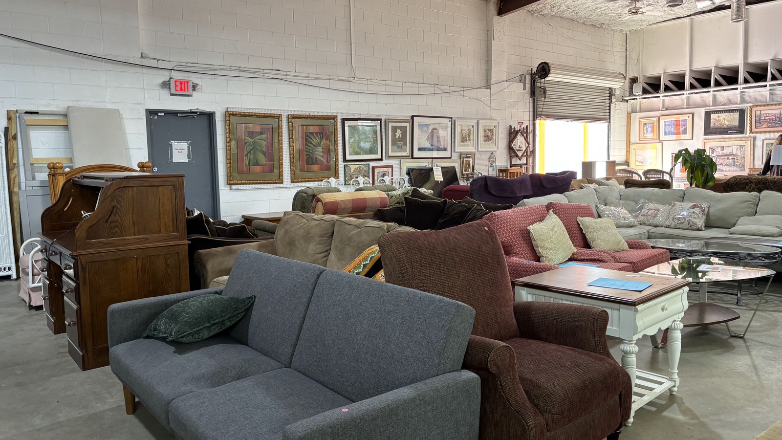 Furniture and framed artwork inside The Litter Box Thrift Store