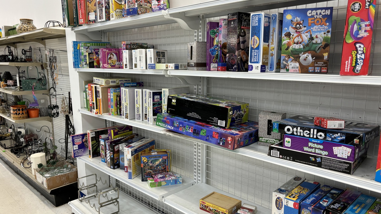 Board games and housewares on organized shelves inside CommunityAid in Selinsgrove