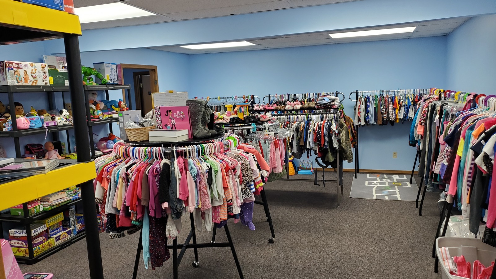 Colorful clothing racks inside Secondhand Treasures in downtown Troy