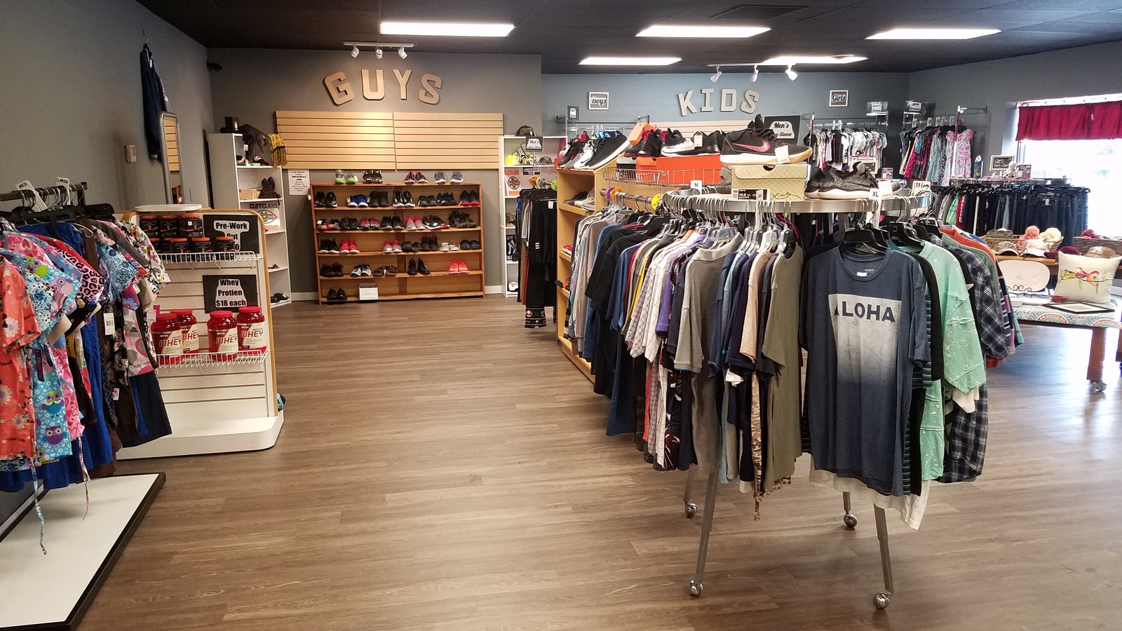 Organized clothing racks inside Trend Again Consignments in Alliance