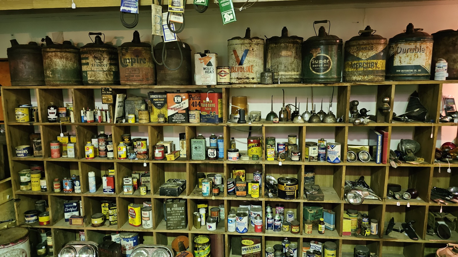 Shelves of vintage advertising tins and oil cans at Pocket Change Antique Mall in Alliance