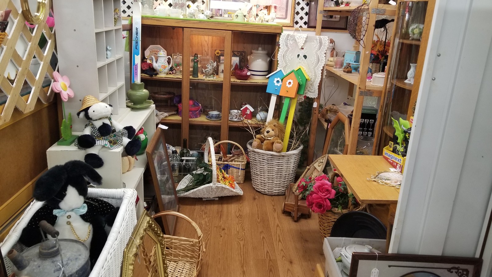 Baskets, decor, and collectibles arranged in a vendor space at Sulaine's Antique Mall