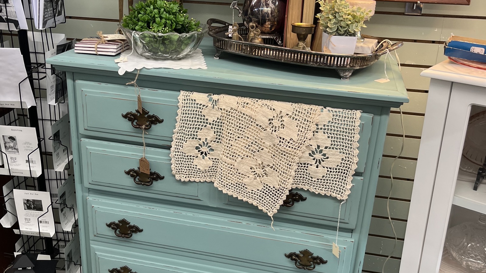 Green vintage dresser with a lace runner at Forest Avenue Antiques in Great Bend