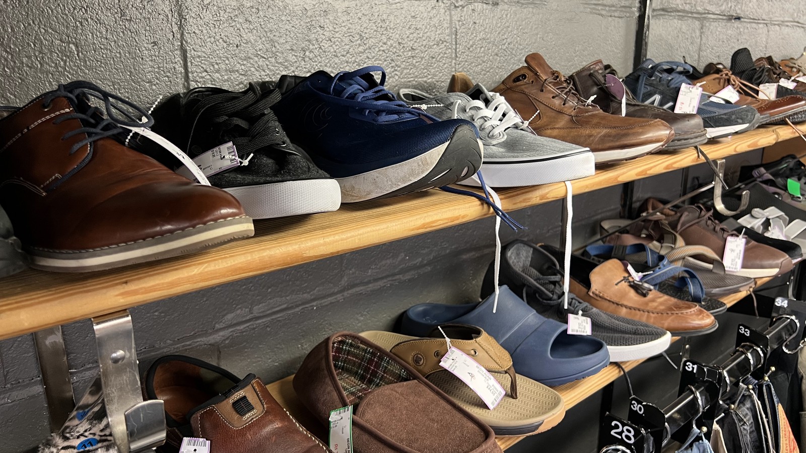 Rows of shoes and neatly arranged clothing at The Begin Again Shoppe in Morristown