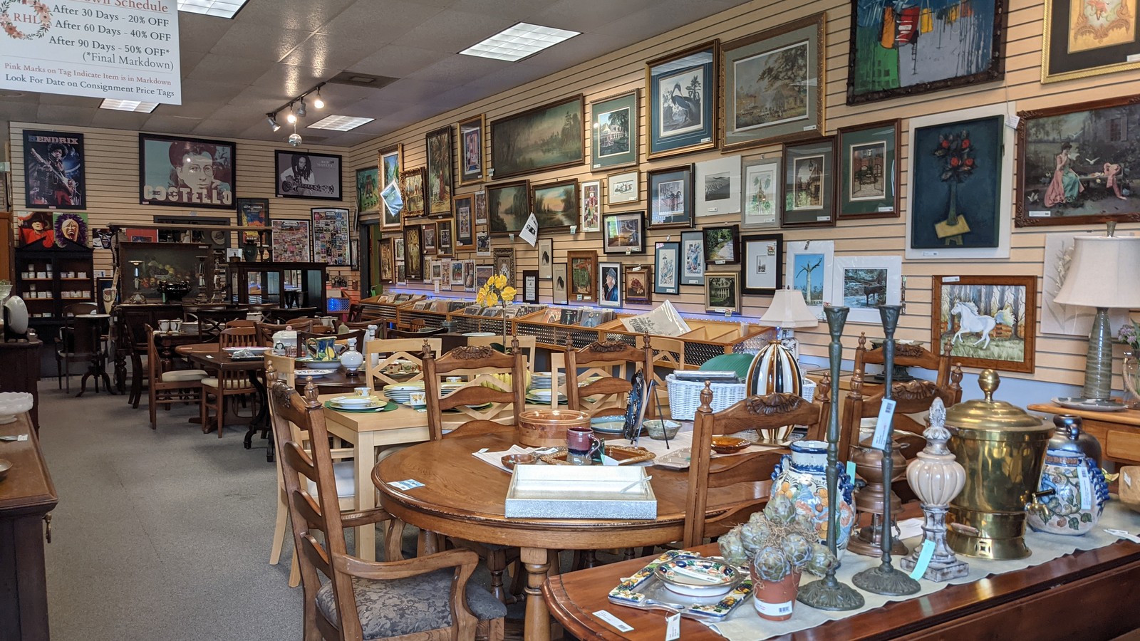 Dining furniture and a gallery wall inside Retreat Home and Lifestyle in Covington