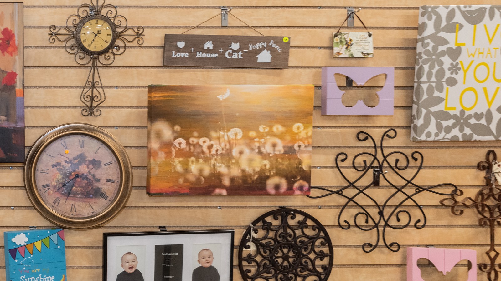 Framed art and decorative metalwork at Northshore Food Bank Resale Shop in Covington