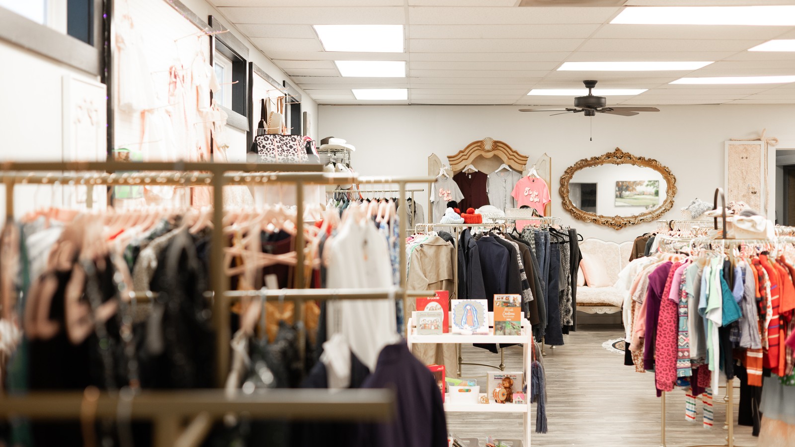 Bright clothing racks and home decor inside The Thrift Store in Covington