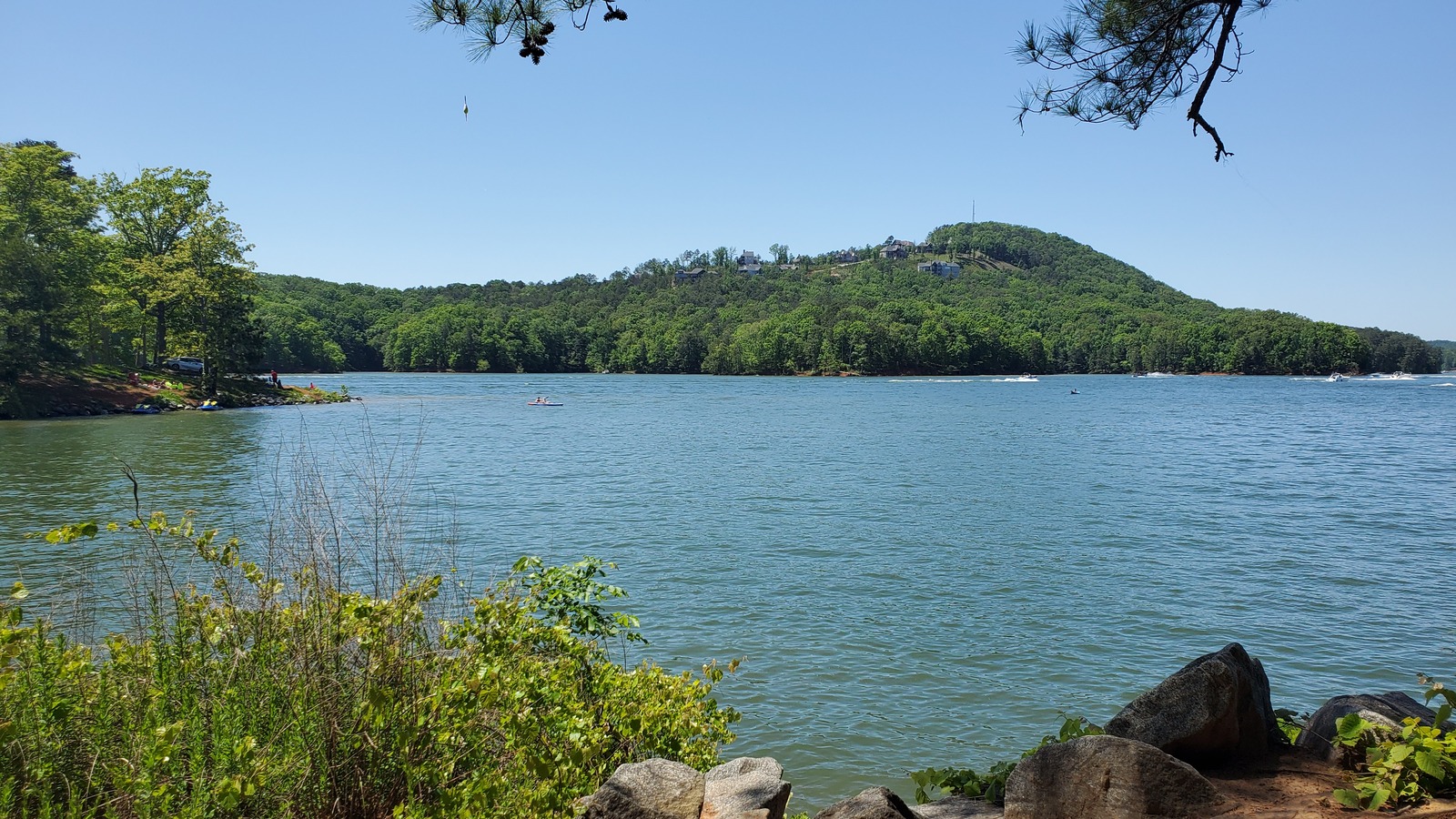 Wooded shoreline point reaching into Lake Allatoona at Red Top Mountain State Park.