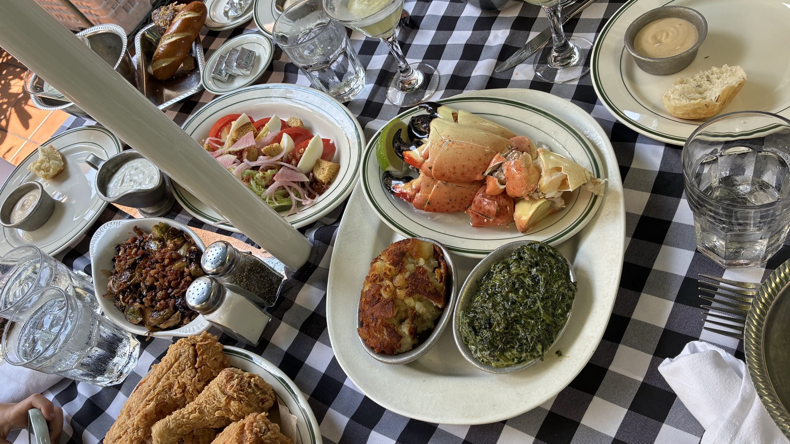 Stone crab claws, hashed brown potatoes, creamed spinach, and sides at Joe's Stone Crab