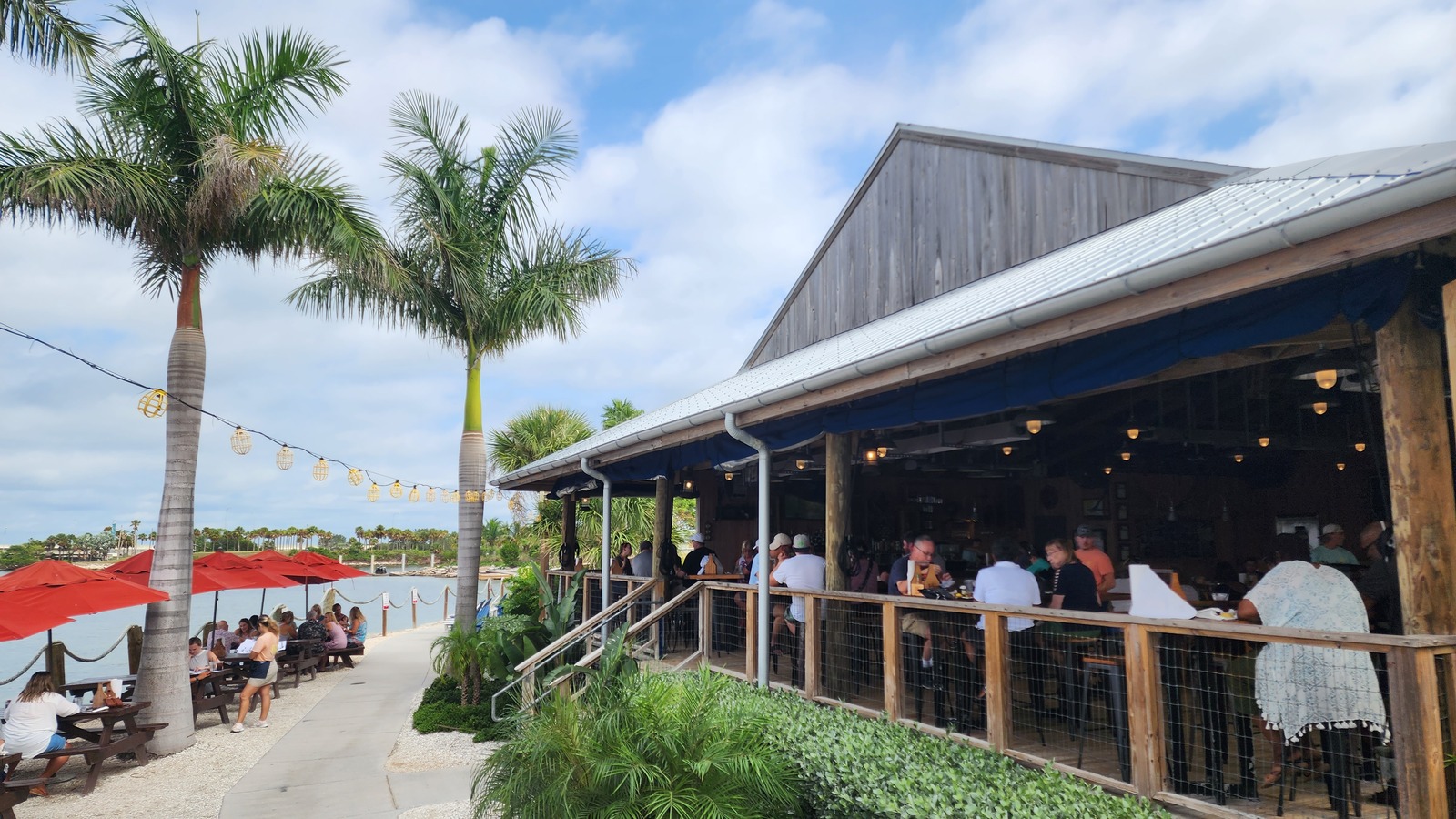 Open-air dining deck and palm-lined exterior at Salt Shack On The Bay in Tampa