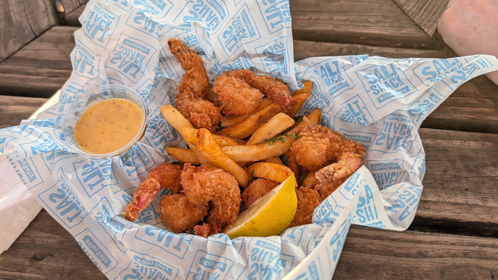 Basket of coconut fried shrimp and fries at Salt Shack On The Bay