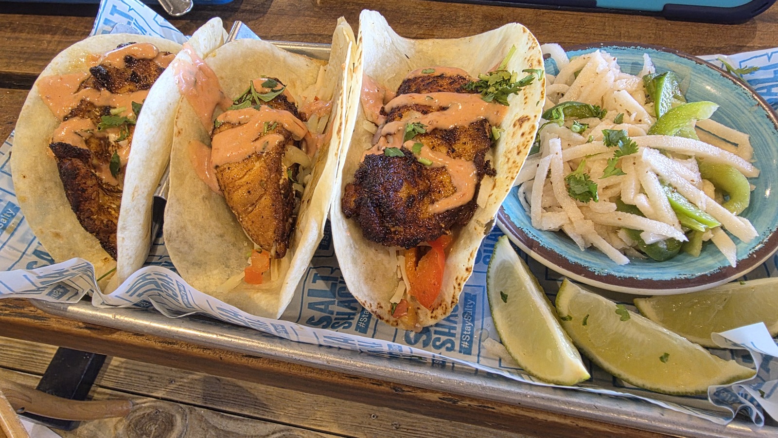 Tray of fish tacos with lime and rice at Salt Shack On The Bay