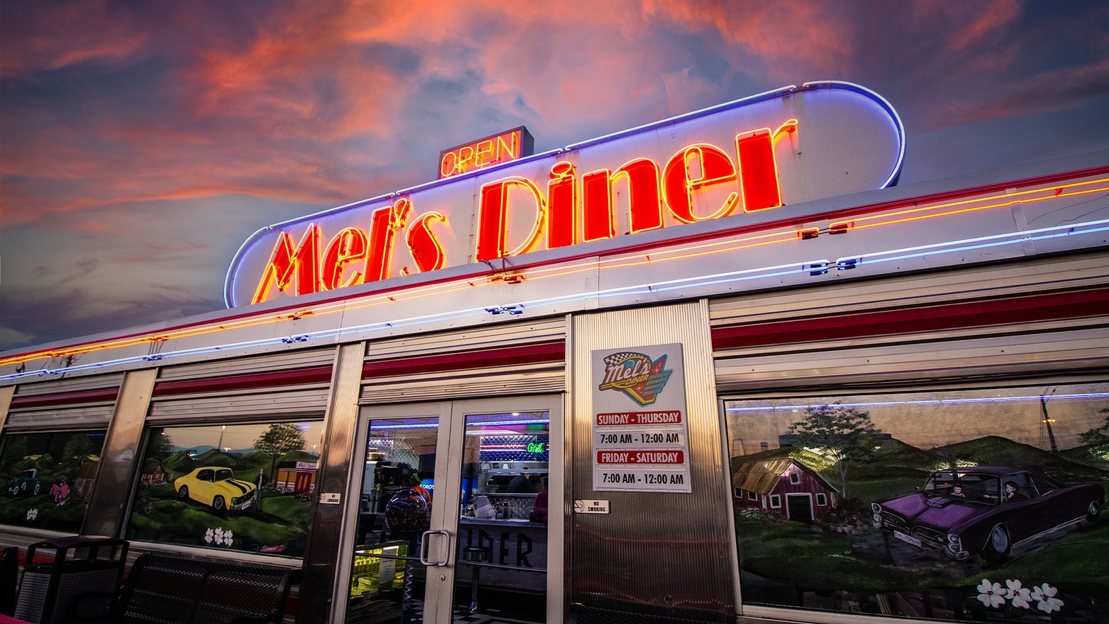 Mel's Diner glowing at sunset in Pigeon Forge with its neon sign lit up