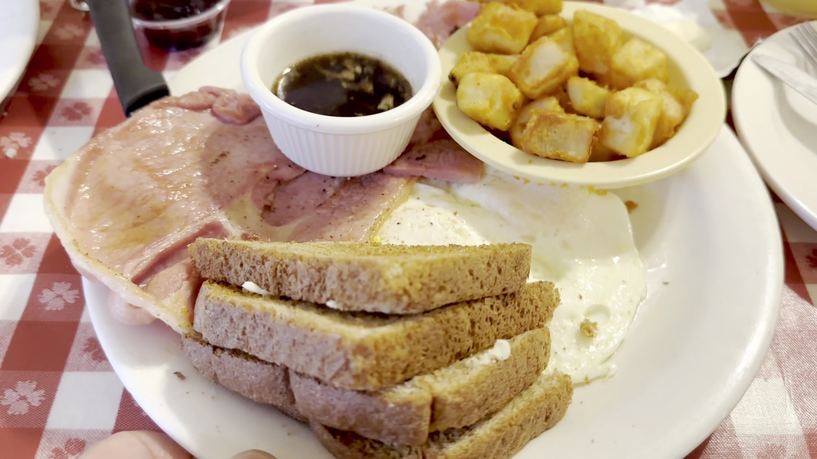 Country ham, eggs, toast, and potatoes on a breakfast plate at The Loveless Cafe