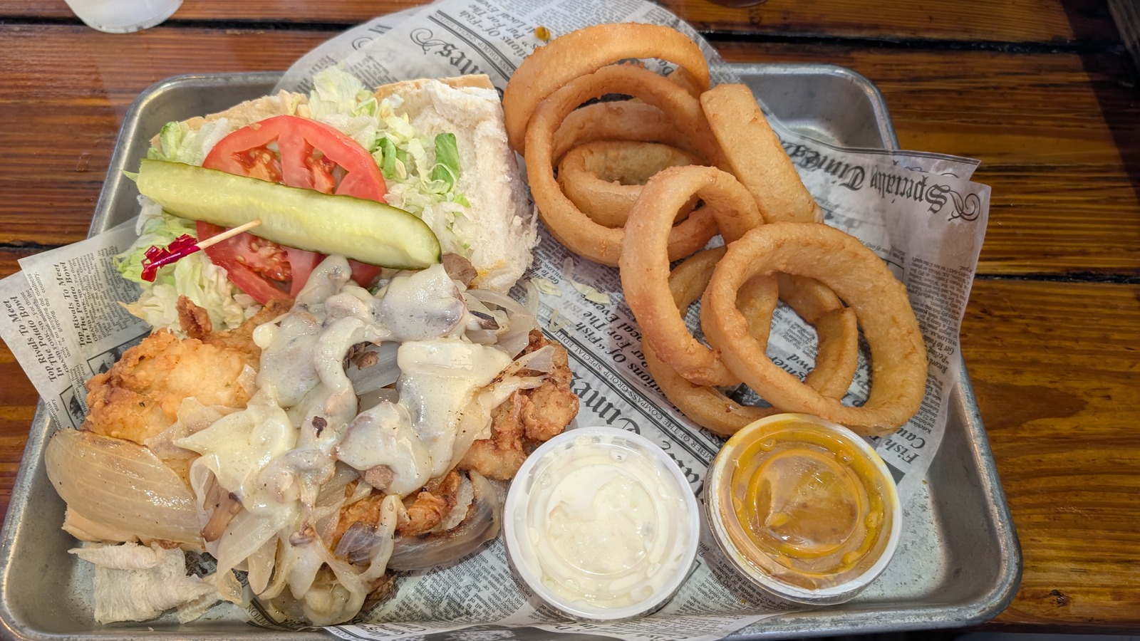 Fried seafood platter with sandwich fixings and onion rings at Hogfish Bar & Grill