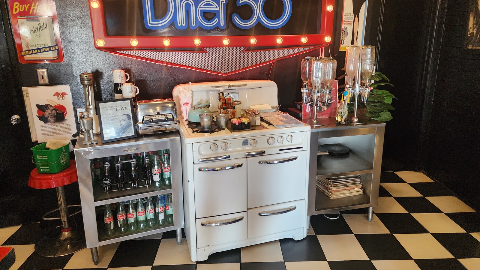 Vintage stove display and glowing Diner 50 sign inside the dining room