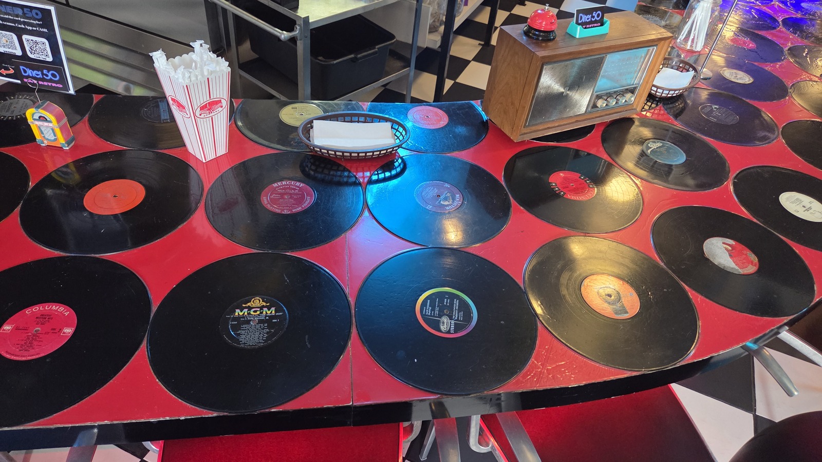 Vinyl record tabletop and diner booth seating at Diner 50