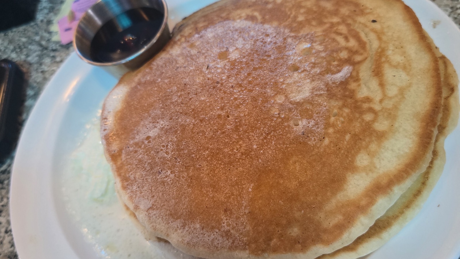 Golden pancake and syrup pitcher at Diner 50
